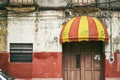 Merida / Yucatan, Mexico - June 1, 2015: The old awning with red and yellow color mount at the door of the building in Merdia, Yuc