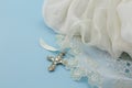 Vintage baby baptism dress on blue background with cross