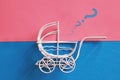 Vintage baby stroller on pink and blue background. Boy or girl question Royalty Free Stock Photo