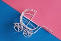 Vintage baby stroller on pink and blue background. Boy or girl question Royalty Free Stock Photo