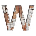 Vintage backdrop font.The letter W cut out of paper against the background of an old wooden wall with cracked paint. Decorative Royalty Free Stock Photo