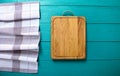 Vintage background. Cutting board and plaid tablecloth on blue wooden table. Top view and mock up. Kitchen concept Royalty Free Stock Photo