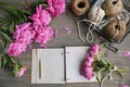 Vintage background, hand made. Pink peony and old scissors, ribbons, notebook for text.