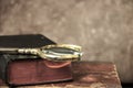 Vintage background. Old books and a loupe. Royalty Free Stock Photo
