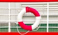 Vintage background with rescue circle on boat. Lifebuoy is mounted on a ship. The circle is red and white Royalty Free Stock Photo