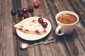 Vintage background. Slice of homemade cherry pie and cup of coffee with fresh cherries on wooden rustic background. Selective