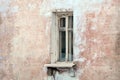 Vintage background with the texture of an old plastered damaged wall with a window. Grunge background of urban decay Royalty Free Stock Photo