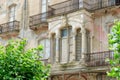 Vintage balcony on an old abandoned and decaying building facade in Portbou, Spain. Vintage architecture. Old fashioned living