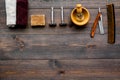 Vintage barbershop tools. Razor, comb, brush on dark wooden background top view copyspace