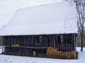 Vintage barn covered in snow, traditional German building