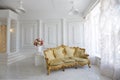 Vintage Baroque gold sofa in a classic light interior