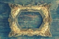 Vintage baroque golden frame on wooden background. Grunge textur Royalty Free Stock Photo