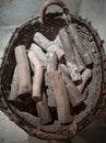 Vintage basket with logs of firewood on concrete floor