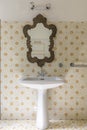 Vintage bathroom in ancient villa with tiles, sink and antique mirror Royalty Free Stock Photo