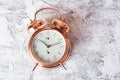 Vintage, beautiful alarm clock made from gold metal on a white texture surface. Good morning. Awakening. top view Royalty Free Stock Photo