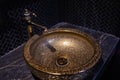 Vintage Beautiful faucet and golden mixer tap on a marble round sink in the bathroom. Interior of an expensive toilet Royalty Free Stock Photo