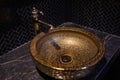 Vintage Beautiful faucet and golden mixer tap on a marble round sink in the bathroom. Interior of an expensive toilet Royalty Free Stock Photo
