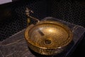 Vintage Beautiful faucet and golden mixer tap on a marble round sink in the bathroom. Interior of an expensive toilet Royalty Free Stock Photo