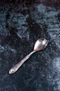 Vintage silver spoon on a grundge blue background