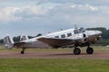 Vintage Beech G18S N45CF twin engine aircraft with highly polished natural metal finish.