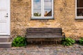 Vintage Bench and tree against blank house wall Royalty Free Stock Photo