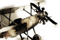 Vintage Bi-Plane Model (sepia, close-up, shallow focus).