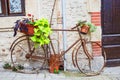 Vintage bicycle with basket of flowers in front of the old rustic house in France, Europe Royalty Free Stock Photo