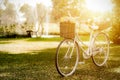Vintage bicycle with basket full of flowers standing in the field, Bicycle at summer grass field, classic Bike, old bicycle style. Royalty Free Stock Photo