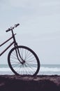 Vintage bicycle on the beach detail, front wheel Royalty Free Stock Photo