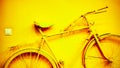 Vintage yellow bicycle on decorative house wall Royalty Free Stock Photo