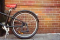 Vintage bicycle detail over brick wall background Royalty Free Stock Photo