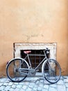 Vintage bicycle in front of a door in Rome, Italy. Royalty Free Stock Photo