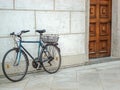 Vintage bicycle near the stone wall on the old town street of Prague and wood ancient door Royalty Free Stock Photo