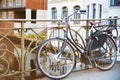 Vintage bicycle parked against iron handrail on a bridge