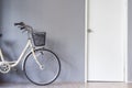 Bicycle parking near the grey wall and white door Royalty Free Stock Photo