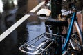 Vintage bicycle parking on retro road rainy day