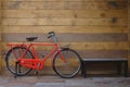 Vintage bicycle red on vintage wooden house wall. Royalty Free Stock Photo