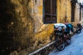 Vintage Bicycle by a yellow ancient wall of an old building in the Ancient City of Hoi An, Vietnam. Horizontal, landscape view Royalty Free Stock Photo