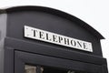 Vintage big black pay phone. Royalty Free Stock Photo