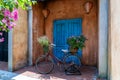 Vintage bike with basket full of flowers next to an old building in Danang, Vietnam, close up Royalty Free Stock Photo