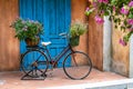 Vintage bike with basket full of flowers next to an old building in Danang, Vietnam, close up Royalty Free Stock Photo