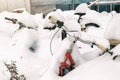 Vintage bike covered with big thick snow layer after blizzard at european city street in winter. Abandoned bicycle buried in Royalty Free Stock Photo