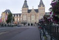 Vintage bike lying down to a amstel river metal fence near to a bike path with rijksmuseum at background Royalty Free Stock Photo