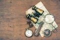 Vintage binoculars, compass, old map, magnifying glass, pocket watches, knife on wooden table background