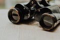 Vintage binoculars on a wooden background