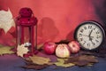 Vintage black alarm clock on autumn leaves. Time change abstract photo. Daylight saving time Royalty Free Stock Photo