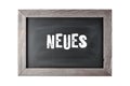 Vintage black board or school chalkboard with wooden frame and  german word Neues  engl. news isolated Royalty Free Stock Photo