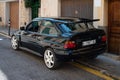 Vintage black Ford Escort RS Cosworth MK5 rally sports car parked on the street in Soller, Spain