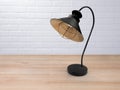 Vintage black lamp on the table against the background of the white loft. Royalty Free Stock Photo