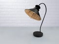 Vintage black lamp on the table against the background of the white loft. Royalty Free Stock Photo